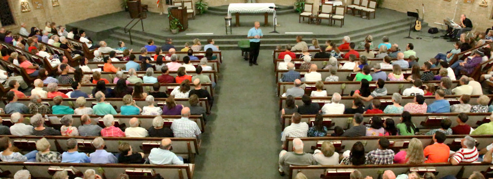 picture shows the arial view of a church and it's parishoners during a talk
