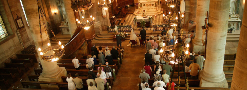 a view of the church from above featuring a congregation at mass